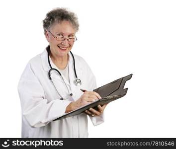 A friendly, mature female doctor making a note in a patient&rsquo;s chart. Isolated on white.