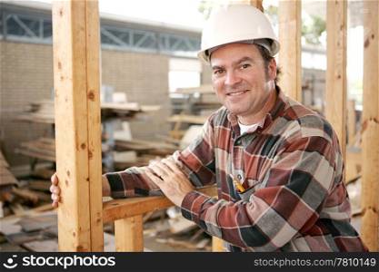A friendly, smiling construction worker on the job. Authentic construction worker on actual construction site.