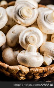 A full basket of fresh mushrooms. Macro background. High quality photo. A full basket of fresh mushrooms.