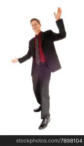 A full body picture of a dancing man in a suit and tie with his arms raisedisolated for white background.