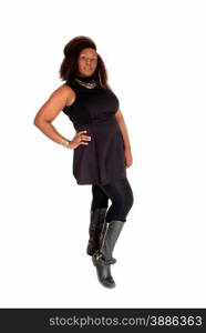 A full body picture on an African American woman in boots and a blackdress standing isolated for white background.