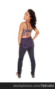 A full length image of a African American women in a colorful top andblue jeans, standing from the back, isolated for white background.