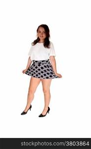 A full length picture of a pretty teenager girl in a white blouse and shortskirt standing isolated for white background.