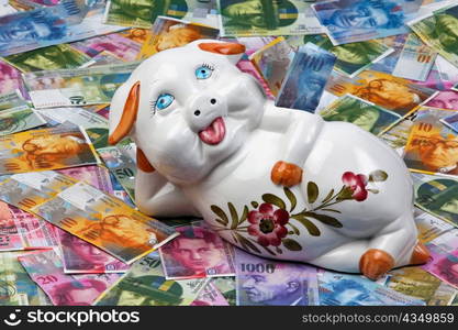 a funny piggy bank is on swiss francs