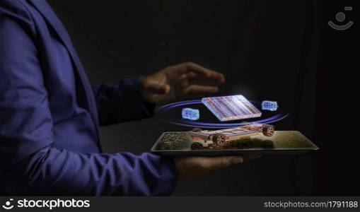 A futuristic Business man is holding a digital tablet, which a hologram is a graphic layout., Future Concept from Hologram