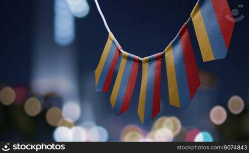 A garland of Armenia national flags on an abstract blurred background.. A garland of Armenia national flags on an abstract blurred background