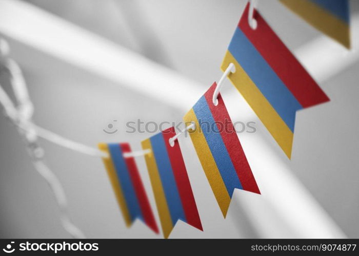 A garland of Armenia national flags on an abstract blurred background.. A garland of Armenia national flags on an abstract blurred background