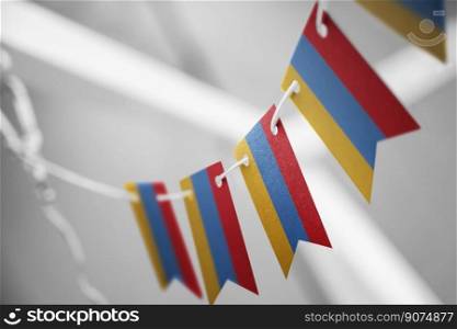 A garland of Armenia national flags on an abstract blurred background.. A garland of Armenia national flags on an abstract blurred background