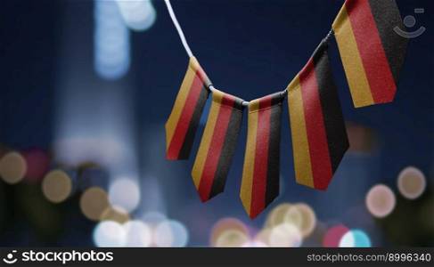A garland of Germany national flags on an abstract blurred background.. A garland of Germany national flags on an abstract blurred background