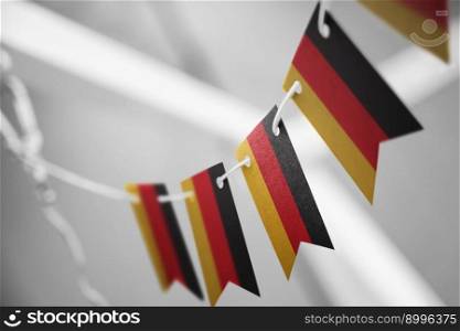 A garland of Germany national flags on an abstract blurred background.. A garland of Germany national flags on an abstract blurred background