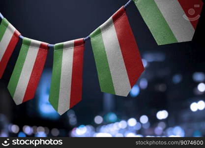 A garland of Hungary national flags on an abstract blurred background.. A garland of Hungary national flags on an abstract blurred background