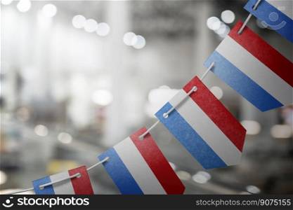 A garland of Netherlands national flags on an abstract blurred background.. A garland of Netherlands national flags on an abstract blurred background