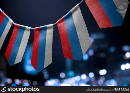 A garland of Russia national flags on an abstract blurred background.. A garland of Russia national flags on an abstract blurred background