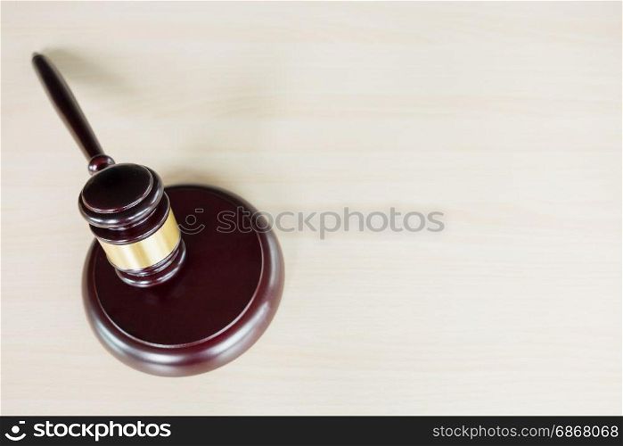 a gavel on a wooden brown desktop, Law, lawyer and justice concept.