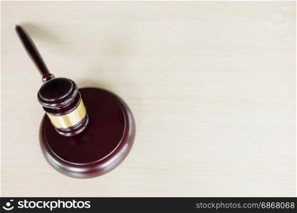 a gavel on a wooden brown desktop, Law, lawyer and justice concept.