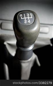 A gear shifter with 5 speeds in an older car