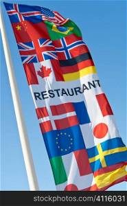 A generic restaurant sign with the flags ofmany nations on it. This is not specific to any particular restaurant but is commercially available and not subject to copyright. The various national flags are listed in the keywords.