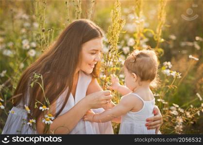 A gentle morning photo among dandelions.. Mother and daughter in a field of dandelions 3006.