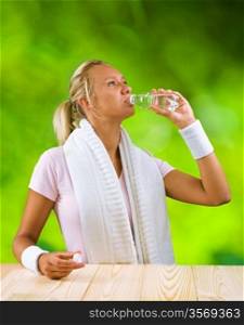 a girl drinking water from bottle