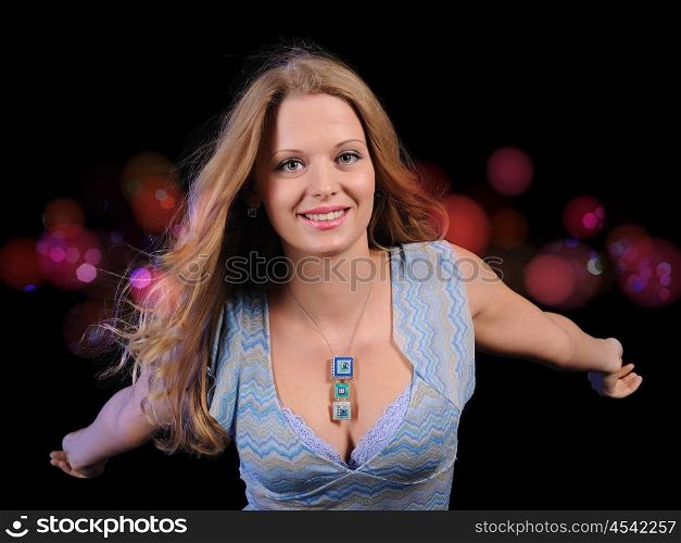 A girl having fun on the background of bright lights in the disco