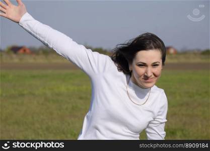 A girl in a white sweater waving her hand and cheerful.. A girl in a white sweater waving her hand and cheerful