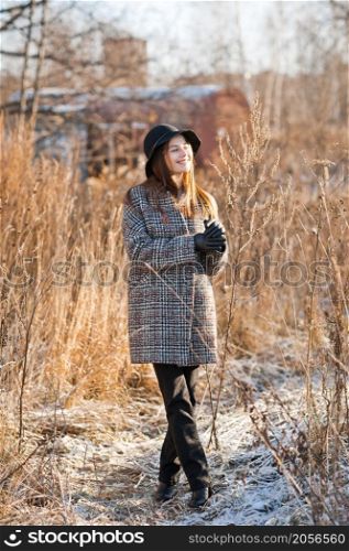 A girl in the reeds on an early spring day.. Portrait of a beautiful girl in the reeds in spring and in a hat 3507.