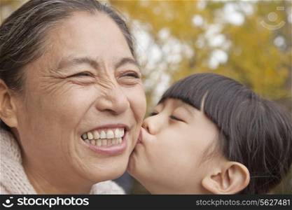 A girl kissing her grandmother