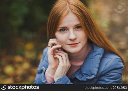 A girl on the background of nature.. A large portrait of a red-haired girl against the background of nature 2748