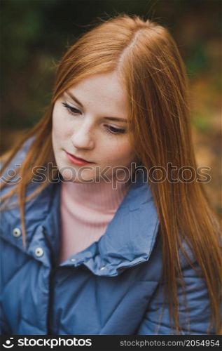 A girl on the background of nature.. A large portrait of a red-haired girl against the background of nature 2749