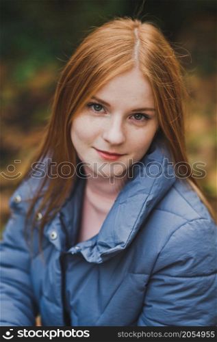 A girl on the background of nature.. A large portrait of a red-haired girl against the background of nature 2750