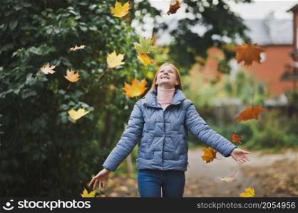 A girl on the background of nature and autumn leaves.. A large portrait of a red-haired girl against the background of nature 2751