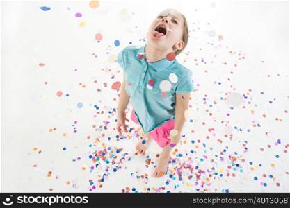 A girl playing in confetti