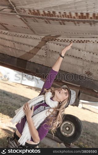 A girl portrait on a old airplane background