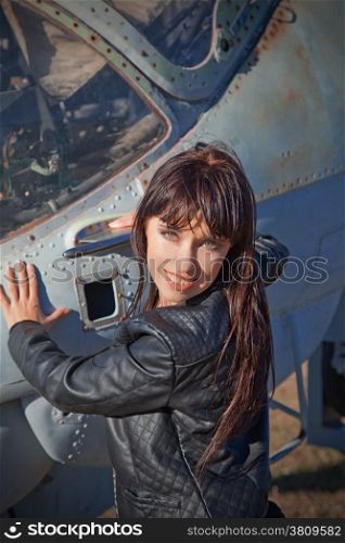 A girl portrait on a old helicopter background