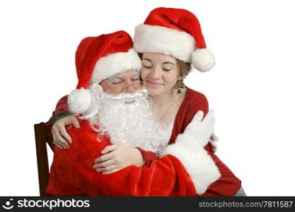 A girl sitting on Santa&rsquo;s lap and giving him a hug. Isolated on white.
