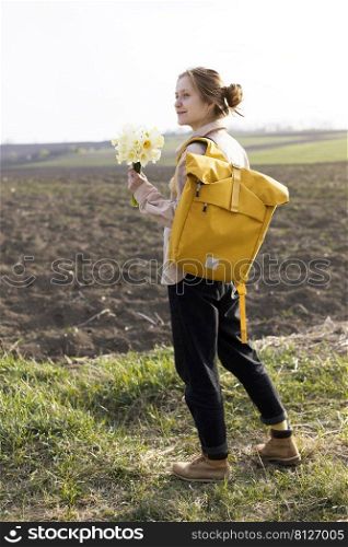 a girl walks through the fields with a bouquet of daffodils a bouquet of daffodils 