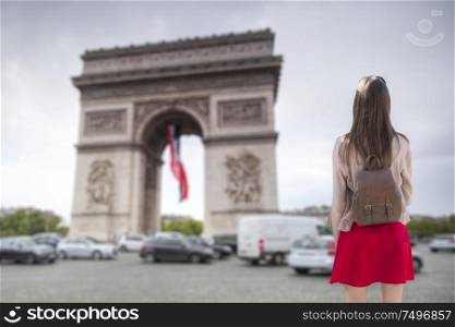 A girl walks through the streets of Paris