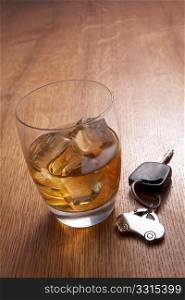 A glass of alcohol and car keys