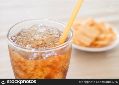 A glass of cola with snack on white plate , stock photo