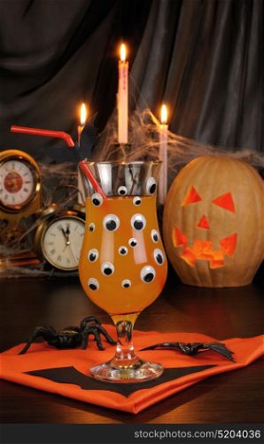 A glass of drink on the table in honor of Halloween