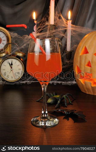 A glass of drink on the table in honor of Halloween