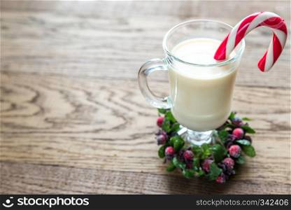 A glass of eggnog with mince pies