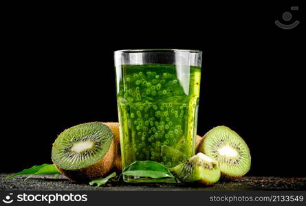 A glass of fresh kiwi juice. On a black background. High quality photo. A glass of fresh kiwi juice.