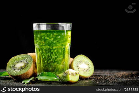 A glass of fresh kiwi juice. On a black background. High quality photo. A glass of fresh kiwi juice.