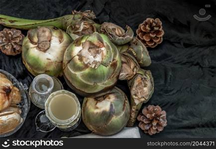 A glass of Fresh palm juice and glass bottle at dark background. Tropical Healthy Refreshment Fruit. Sweet and Fresh, Top view, No focus, specifically.