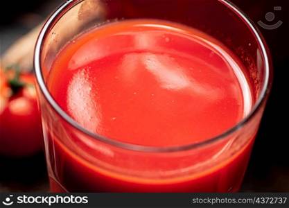 A glass of fresh tomato juice. Texture of tomato juice. High quality photo. A glass of fresh tomato juice.
