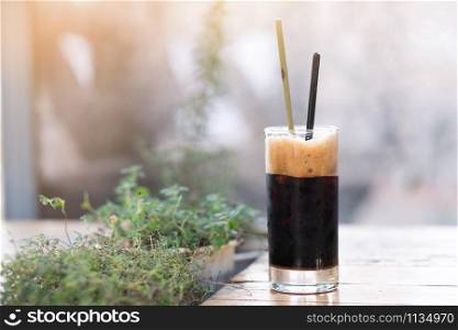 A glass of ice americano in coffee cafe