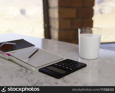 A glass of milk on table in home office.