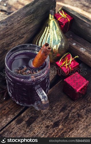 A glass of mulled wine. glass of hot wine with aromatic spices in stylish wooden box