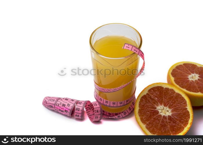 A glass of orange juice on a white background with centimeter and grapefruit. The concept of healthy eating.. A glass of orange juice on a white background with centimeter and grapefruit.